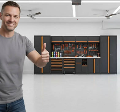 Man giving thumbs up in modern garage with organized tool workbench and storage cabinets
