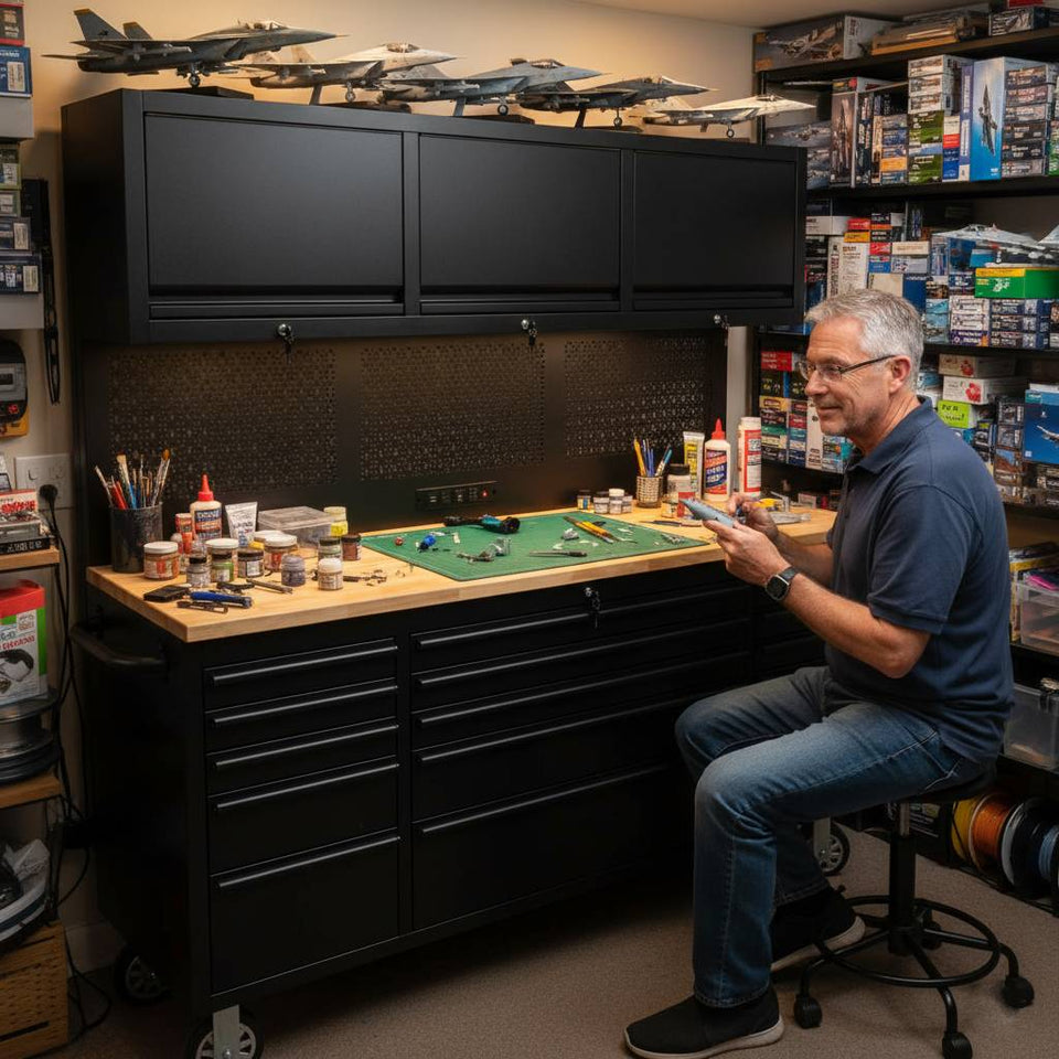 Man working on scale model aircraft at organized tool workbench with storage cabinets