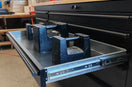 Heavy-duty tool chest drawer open with metal weights testing drawer slides in workshop