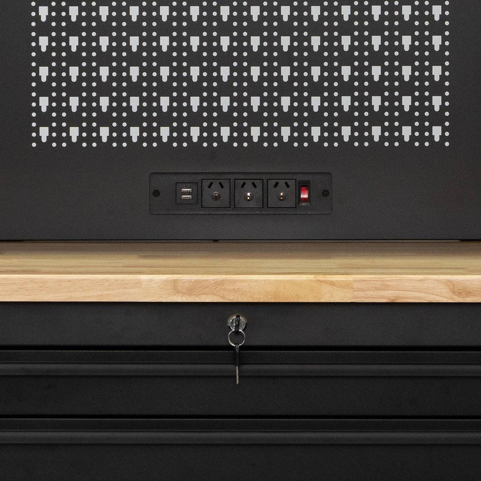 Workbench power panel with USB ports, wood surface, pegboard back, and lockable drawers