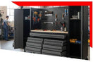 Modern black tool workbench with pegboard, drawers, and organized tool storage in a workshop