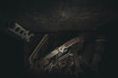 stainless steel hand tool on black wooden table