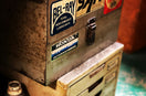 a metal box with some stickers on it