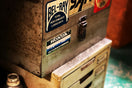a metal box with some stickers on it
