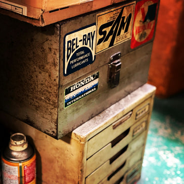 a metal box with some stickers on it