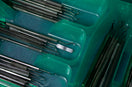 a green box filled with lots of surgical tools
