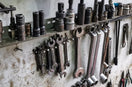 a bunch of tools are hanging on a wall