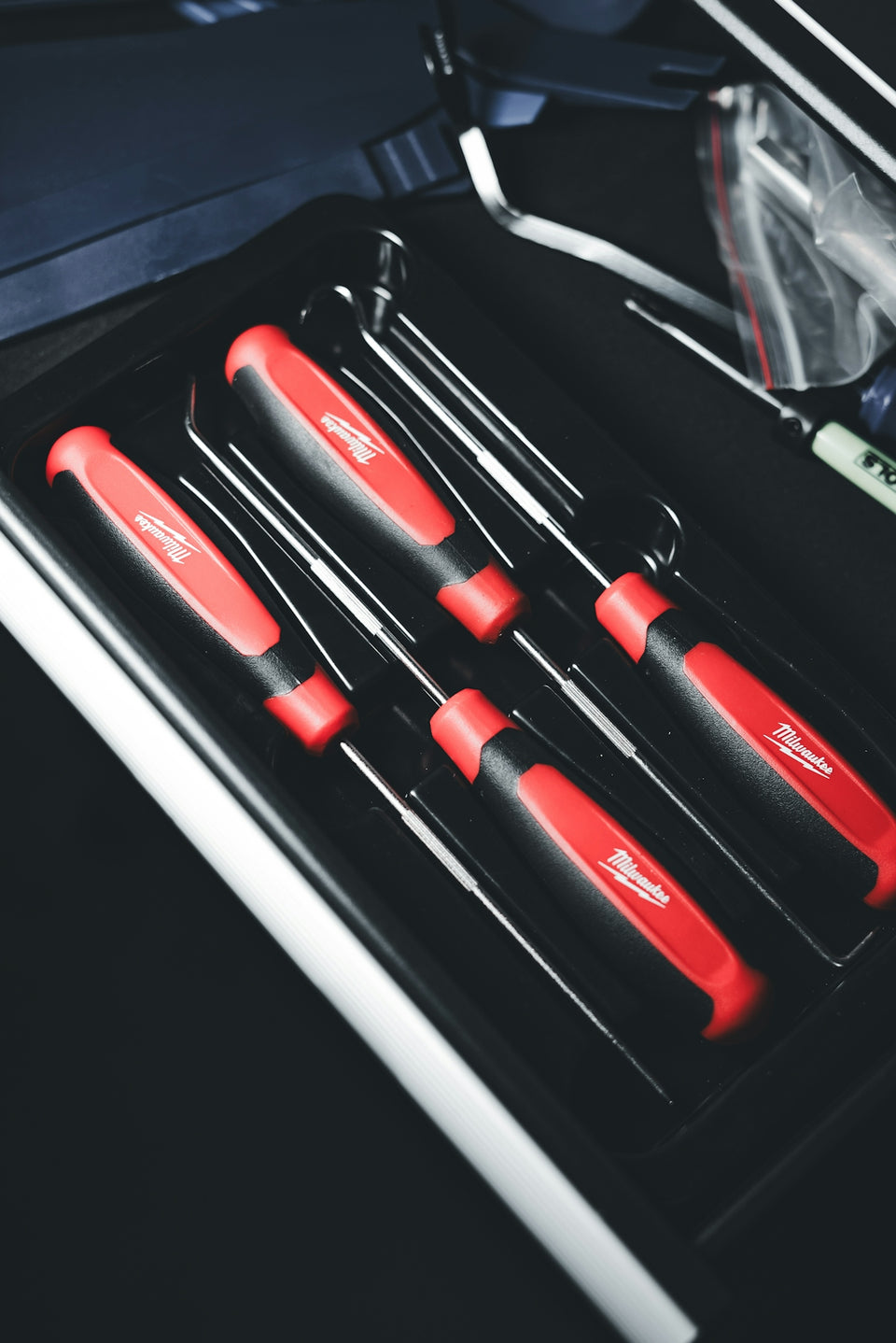 a set of red and black kitchen knives in a case