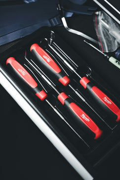 a set of red and black kitchen knives in a case