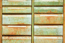 an old rusty green dresser sitting on top of a grass covered field