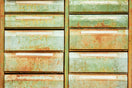 an old rusty green dresser sitting on top of a grass covered field
