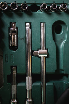 a green box with a bunch of tools inside of it