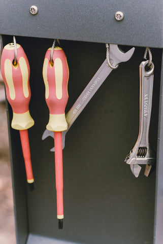 A pair of scissors and a wrench in a box