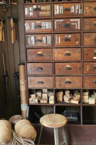An old wooden cabinet filled with tools