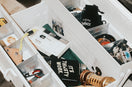 An open white toolbox filled with various tools and items.