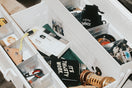 An open white toolbox filled with various tools and items.
