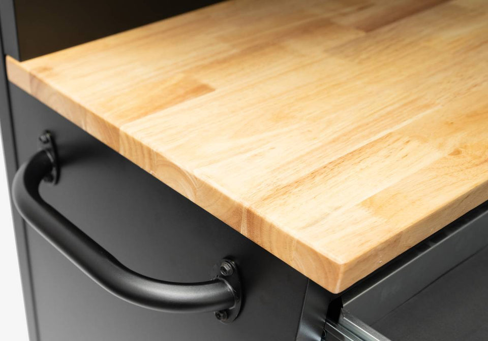 Close-up of a rubberwood workbench top with black metal frame and handle