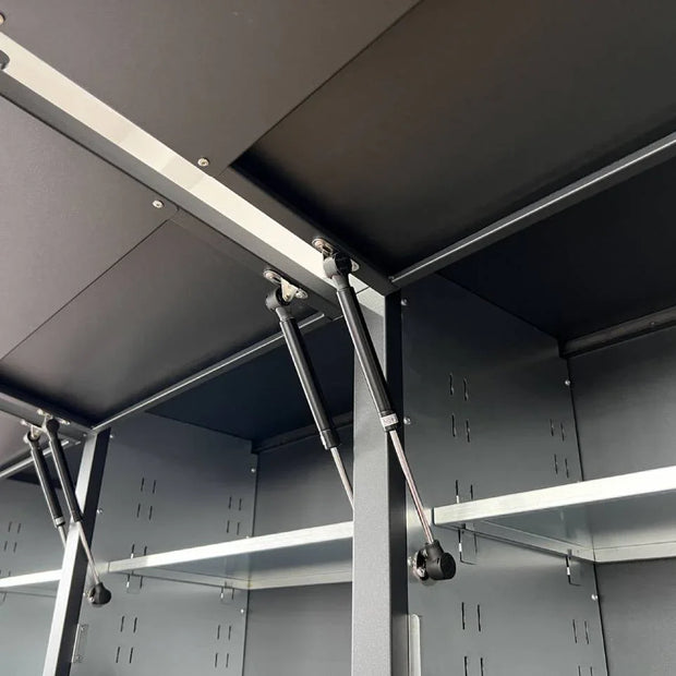 Close-up of heavy-duty steel storage cabinet gas struts and adjustable metal shelves