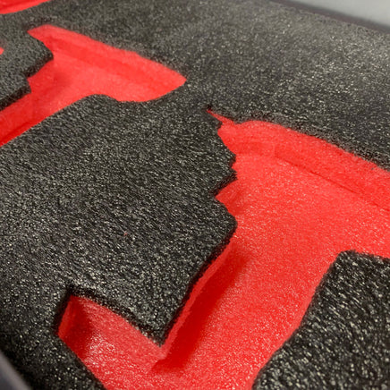 Close-up of red and black tool drawer foam insert with cutouts for tool organization