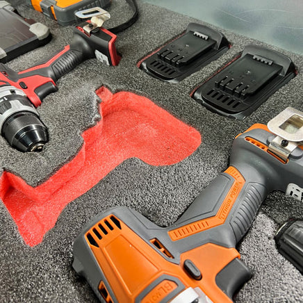 Cordless power drills and battery chargers in foam tool organizer for workshop storage